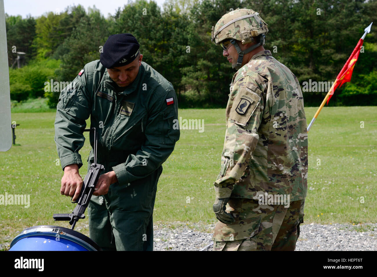 A U.S. soldier, assigned to the 173rd Airborne Brigade, ensures that the Polish soldier, assigned to the 34th Armor Cavalry Brigade, clears his PM-84 Glauberyt, as part of the Strong Europe Tank Challenge (SETC), at the 7th Army Joint Multinational Training Command’s Grafenwoehr Training Area, Grafenwoehr, Germany, May 10, 2016. The SETC is co-hosted by U.S. Army Europe and the German Bundeswehr, May 10-13, 2016. The competition is designed to foster military partnership while promoting NATO interoperability. Seven platoons from six NATO nations are competing in SETC - the first multinational  Stock Photo