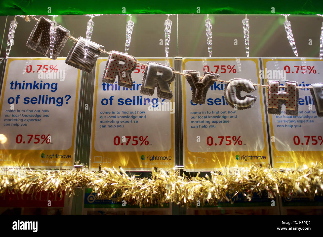 A high Street shop window, decorated for christmas with display of goods on sale. Stock Photo