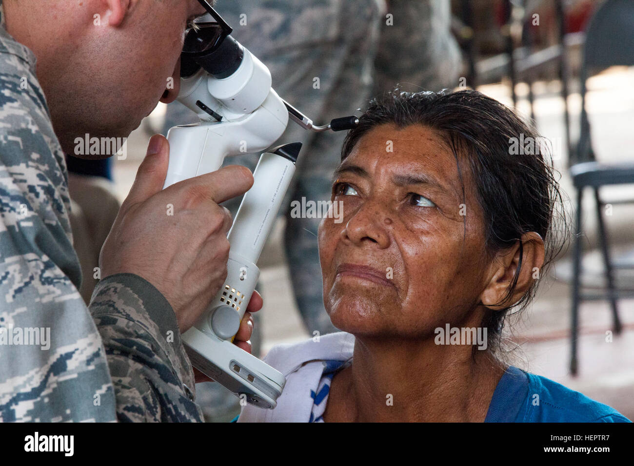 U.S Air Force Maj. Robert Carlson of the 22nd  Medical Group, McConnell Air Force Base examines patient's vision using a slit-lamp device in La Blanca, Guatemala, May 24,2016. Task Force Red Wolf and Army South conducts Humanitarian Civil Assistance Training to include tatical level construction projects and medical readiness Training Exercises providing medical access and building schools in guatemala with the Guatamalan Government and non government agencies from 05Mar16 to 18JUN16 in order to improve the mission readiness of US Forces and to provide a lasting benefit to the people to Guatem Stock Photo