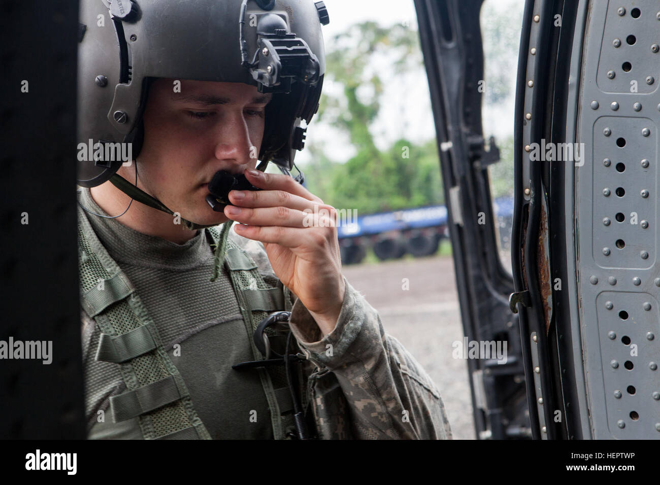 U.S. Army Spc. Jordan Ford of the 238th Task Force Medical Evacuation Company, New Hampshire National Guard, conducts radio check in preparation for take off in a UH-60 Black Hawk helicopter in Coatepeque, Guatemala, May 27, 2016. Task Force Red Wolf and Army South conducts Humanitarian Civil Assistance Training to include tatical level construction projects and medical readiness Training Exercises providing medical access and building schools in guatemala with the Guatamalan Government and non government agencies from 05Mar16 to 18JUN16 in order to improve the mission readiness of US Forces a Stock Photo