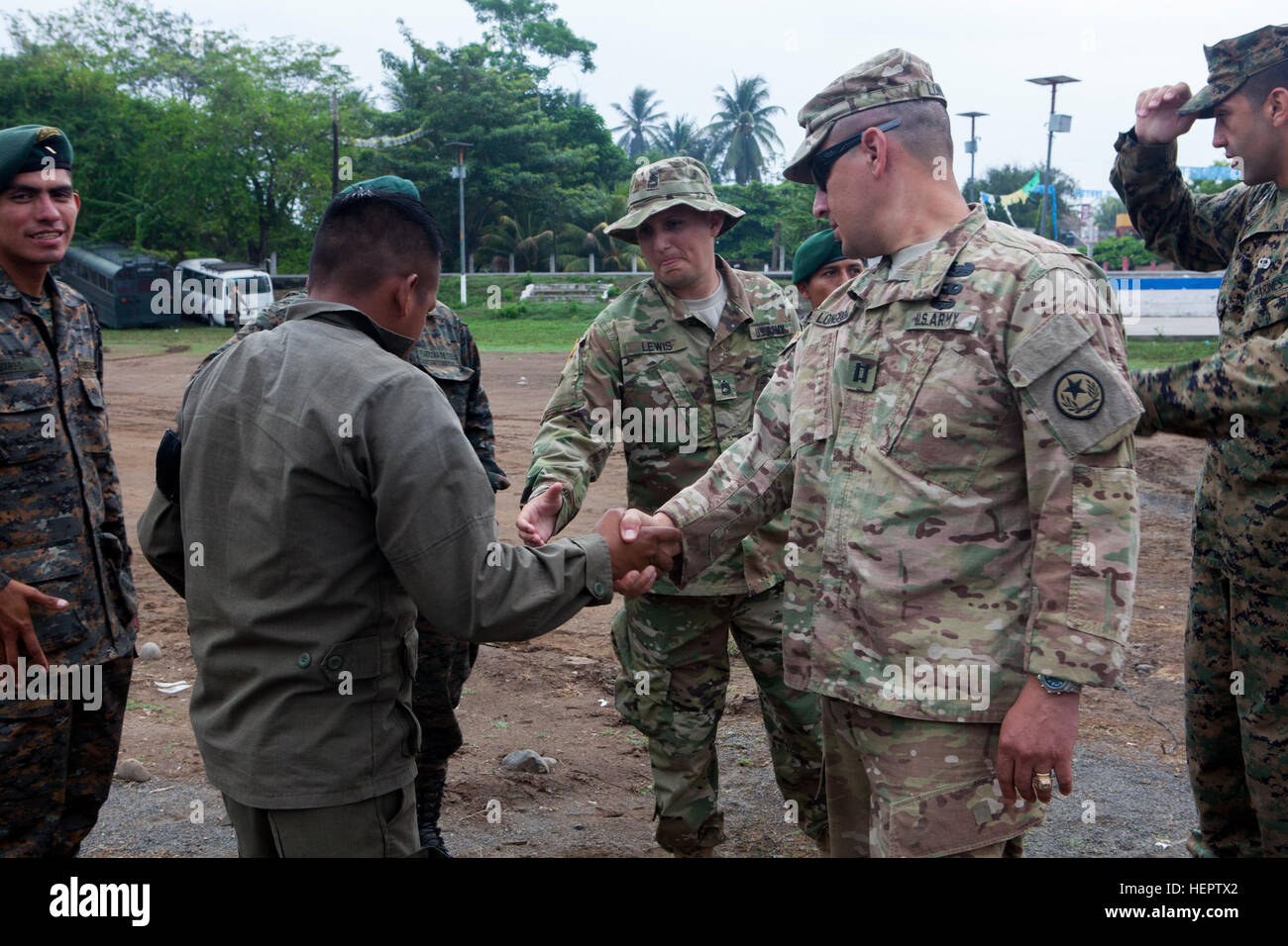 U.S. Army Capt.  Raymond Longoria and Sgt. 1St Class Joel Lewis of the 71st TIOG, Texas Army National Guard, meets the new Guatemalan Army security team at a medical readiness exercise in La Blanca, Guatemala, May 28, 2016. Task Force Red Wolf and Army South conducts Humanitarian Civil Assistance Training to include tatical level construction projects and medical readiness Training Exercises providing medical access and building schools in guatemala with the Guatamalan Government and non government agencies from 05Mar16 to 18JUN16 in order to improve the mission readiness of US Forces and to p Stock Photo