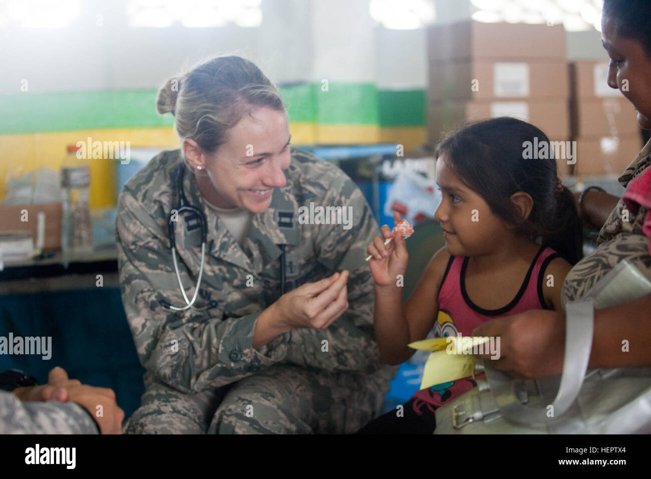 U.S. Air Force Capt. Erin Senozan of the 81st Medical Group, Keesler Air Force Base, gives a child candy after a check up during a medical readiness exercise in La Blanca, Guatemala, May 28, 2016. Task Force Red Wolf and Army South conducts Humanitarian Civil Assistance Training to include tatical level construction projects and medical readiness Training Exercises providing medical access and building schools in guatemala with the Guatamalan Government and non government agencies from 05Mar16 to 18JUN16 in order to improve the mission readiness of US Forces and to provide a lasting benefit to Stock Photo