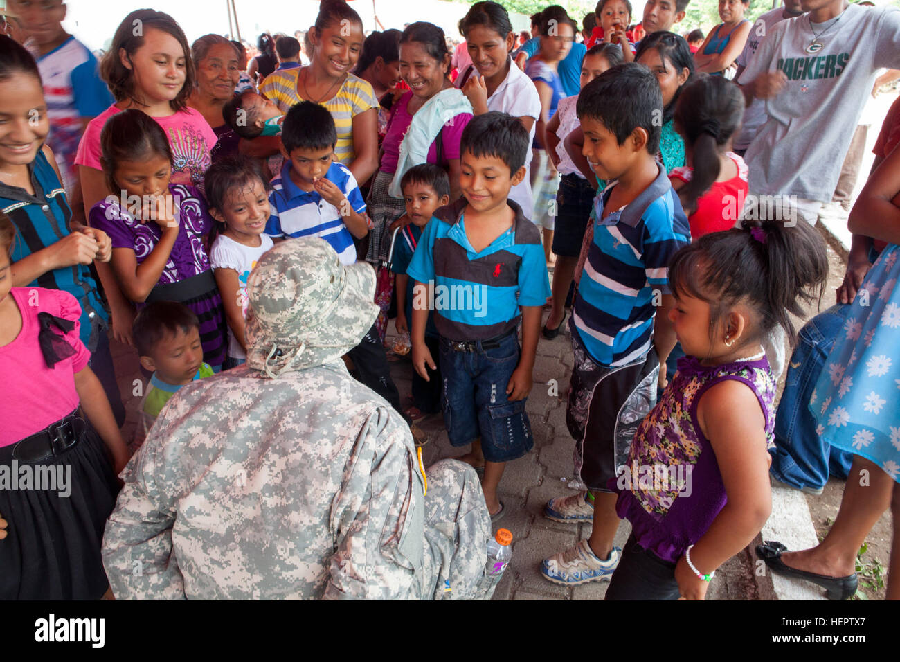 U.S. Army Sgt. Leonardo Cabrera of the 105th Quartermaster Company, Puerto Rico National Guard, plays with local children and gives out candy while they wait in line to in-process a medical readiness exercise in La Blanca, Guatemala, May 28, 2016. Task Force Red Wolf and Army South conducts Humanitarian Civil Assistance Training to include tatical level construction projects and medical readiness Training Exercises providing medical access and building schools in guatemala with the Guatamalan Government and non government agencies from 05Mar16 to 18JUN16 in order to improve the mission readine Stock Photo