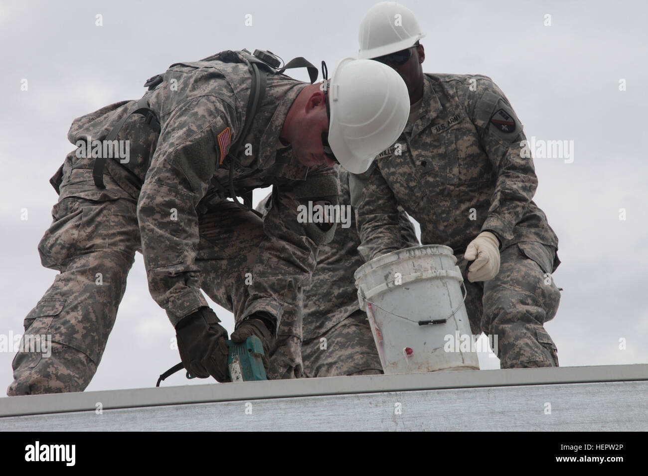 U.S. Army Spc. Westen Kimberland, assigned to the 1020th Engineering Battalion, Arizona National Guard, drill holes to attach a tin roof to a clinic in La Blanca, Guatemala, June 6, 2016. Task Force Red Wolf and Army South conducts Humanitarian Civil Assistance Training to include tactical level construction projects and Medical Readiness Training Exercises providing medical access and building schools in Guatemala with the Guatemalan Government and non-government agencies from 05MAR16 to 18JUN16 in order to improve the mission readiness of US Forces and to provide a lasting benefit to the peo Stock Photo