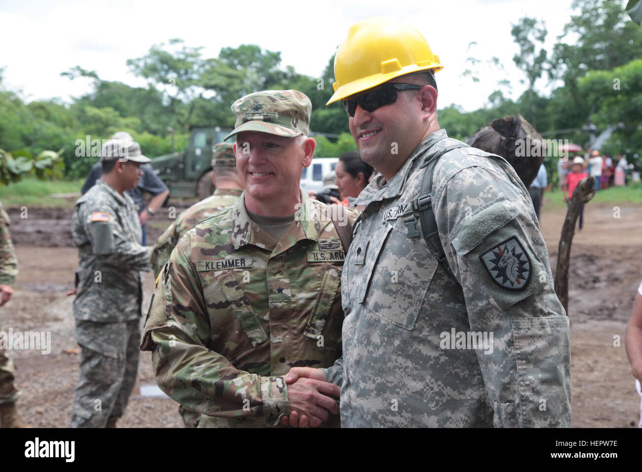 U.S. Army Brig. Gen. Keith Klemmer the Arkansas adjutant general, (left) greets Spc. Jorge Martinez assigned to the 223 Regiment Training Institute, California National Guard, (right) at the Catarina construction site, Guatemala, June 8, 2016. Task Force Red Wolf and Army South conducts Humanitarian Civil Assistance Training to include tactical level construction projects and Medical Readiness Training Exercises providing medical access and building schools in Guatemala with the Guatemalan Government and non-government agencies from 05MAR16 to 18JUN16 in order to improve the mission readiness  Stock Photo