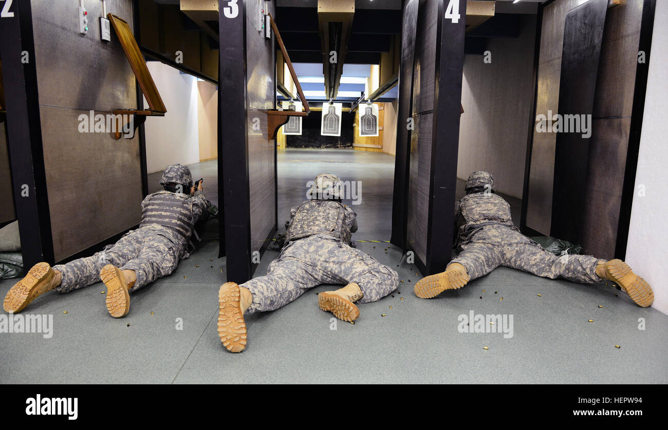 U.S. Soldiers assigned to 839th Transportation Battalion from Camp Darby shoot in the prone position with a M-9 Beretta pistol during a marksmanship training exercise at the indoor range, Caserma Ederle, Vicenza, Italy, June 8, 2016. (U.S. Army Photos by Visual Information Specialist Davide Dalla Massara /Released) U.S. Soldiers assigned to 839th Transportation Battalion from Camp Darby shoot with M-9 Beretta pistol at Caserma Ederle Vicenza. 160608-A-DO858-060 Stock Photo