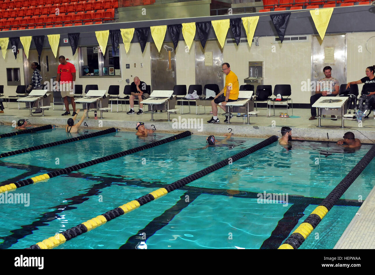 Soldiers from the Team Army swim team receive swimming tips from