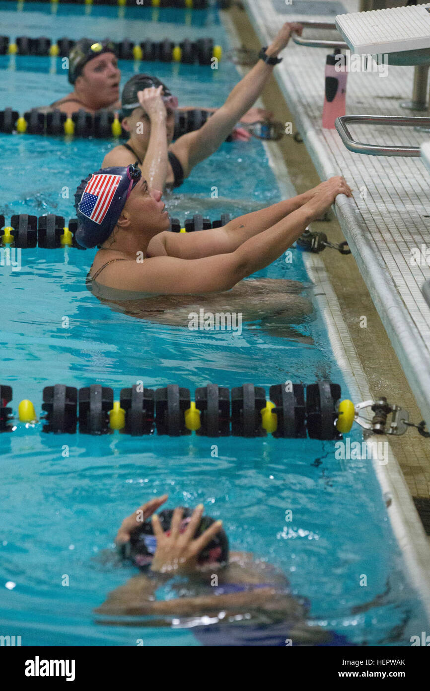 Team Army competitors listen to the coach give advice on her swimming ...