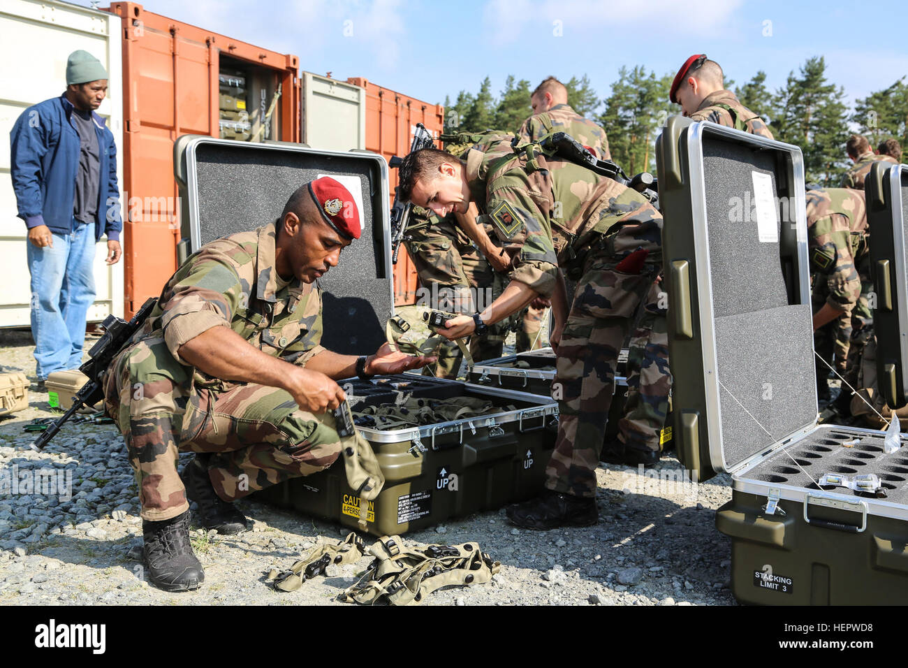 French soldiers of the 17th Parachute Engineer Regiment organize equipment while conducting Multiple Integrated Laser Engagement System (MILES) installation for Swift Response 16 training exercise at the Grafenwoehr Training Area, a part of the Joint Multinational Readiness Center, in Grafenwoehr, Germany, Jun. 10, 2016. Exercise Swift Response is one of the premier military crisis response training events for multi-national airborne forces in the world. The exercise is designed to enhance the readiness of the combat core of the U.S. Global Response Force – currently the 82nd Airborne Division Stock Photo