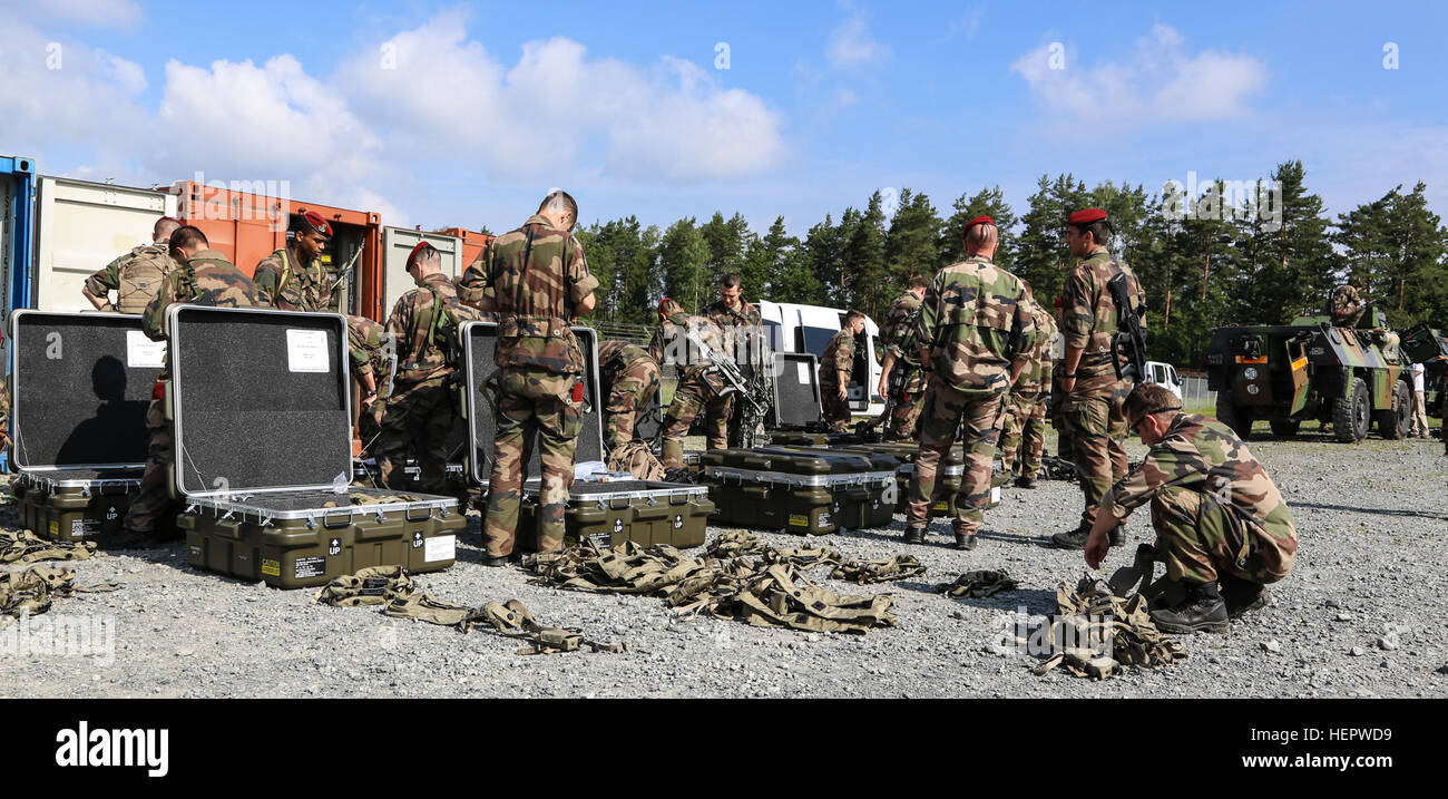French soldiers of the 17th Parachute Engineer Regiment organize components of Multiple Integrated Laser Engagement System (MILES) prior to installation during Swift Response 16 training exercise at the Grafenwoehr Training Area, a part of the Joint Multinational Readiness Center, in Grafenwoehr, Germany, Jun. 10, 2016. Exercise Swift Response is one of the premier military crisis response training events for multi-national airborne forces in the world. The exercise is designed to enhance the readiness of the combat core of the U.S. Global Response Force – currently the 82nd Airborne Division’ Stock Photo
