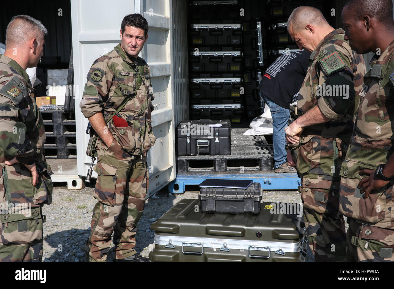 French soldiers of the 17th Parachute Engineer Regiment discuss plans while conducting Multiple Integrated Laser Engagement System (MILES) operations during Swift Response 16 training exercise at the Grafenwoehr, Training Area, a part of the Joint Multinational Readiness Center, in Grafenwoehr, Germany, Jun. 10, 2016. Exercise Swift Response is one of the premier military crisis response training events for multi-national airborne forces in the world. The exercise is designed to enhance the readiness of the combat core of the U.S. Global Response Force – currently the 82nd Airborne Division’s  Stock Photo
