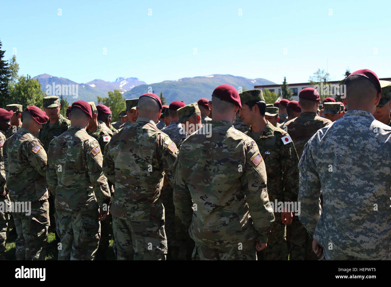 Paratroopers with 3rd Battalion, 509th Parachute Infantry Regiment receive Japanese parachutist badges during the Exercise Arctic Aurora closing ceremony on Pershing Field at Joint Base Elmendorf-Richardson, Alaska June 15, 2016. Arctic Aurora is a yearly bilateral training exercise involving elements of the 4th Infantry Brigade Combat Team (Airborne), 25th Infantry Division and the JGSDF, which focuses on strengthening ties between the two by executing combined small unit airborne proficiency operations and basic small arms marksmanship. (U.S. Army photo by Staff Sgt. Brian Ragin) Arctic Auro Stock Photo