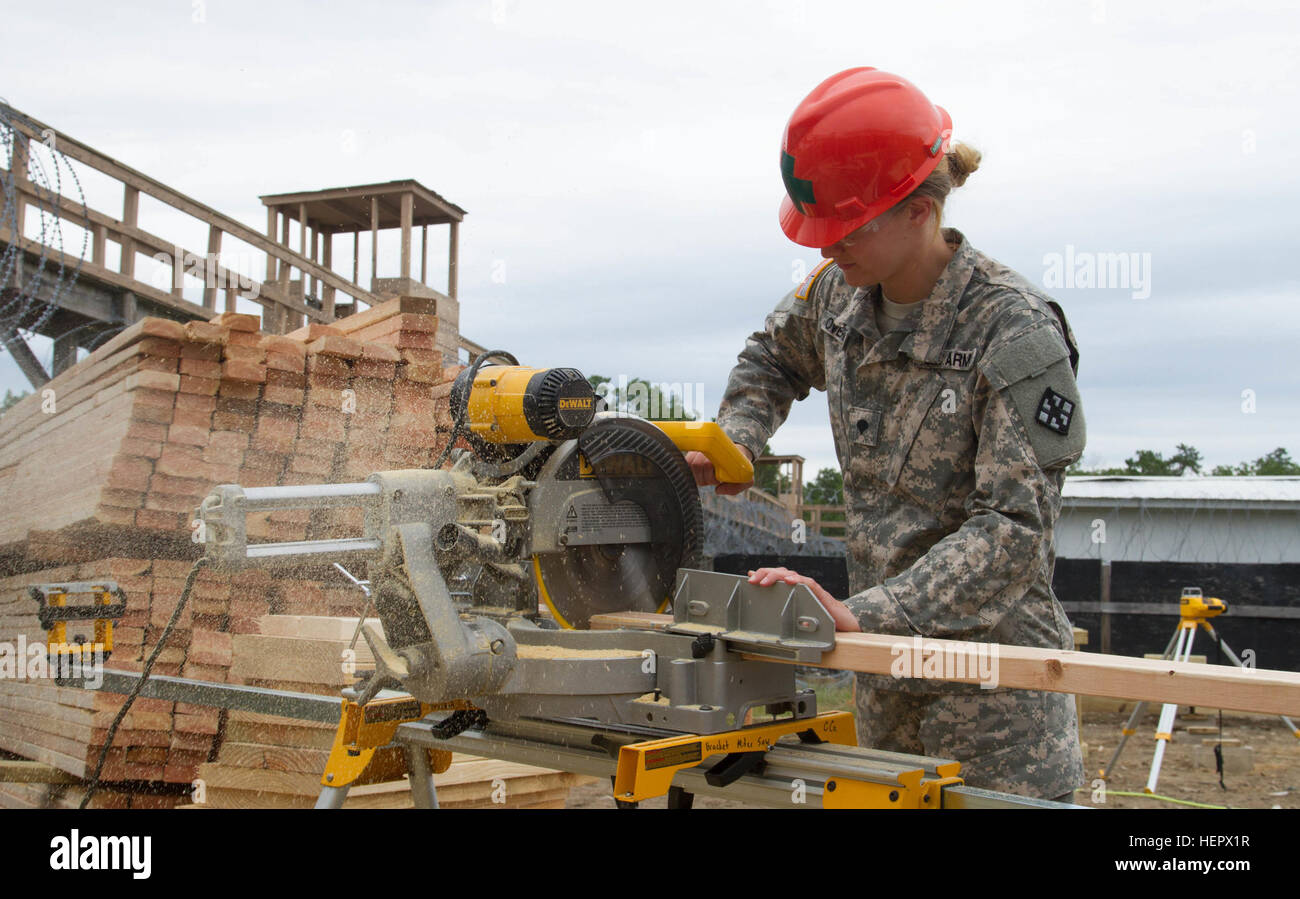 JOINT BASE MCGUIRE-DIX-LAKEHURST, N.J. - Hazleton, Pa. native Spc. Chiarra Overpeck of 412th Engineer Company, based in Scranton, Pa., cuts wood for a frame for a detainee complex during training exercise Castle Installation Related Construction 2016. (U.S. Army photo by Spc. Gary R. Yim, 372nd Mobile Public Affairs Detachment) 412th Engineers build detainee complex 160616-A-JR823-127 Stock Photo