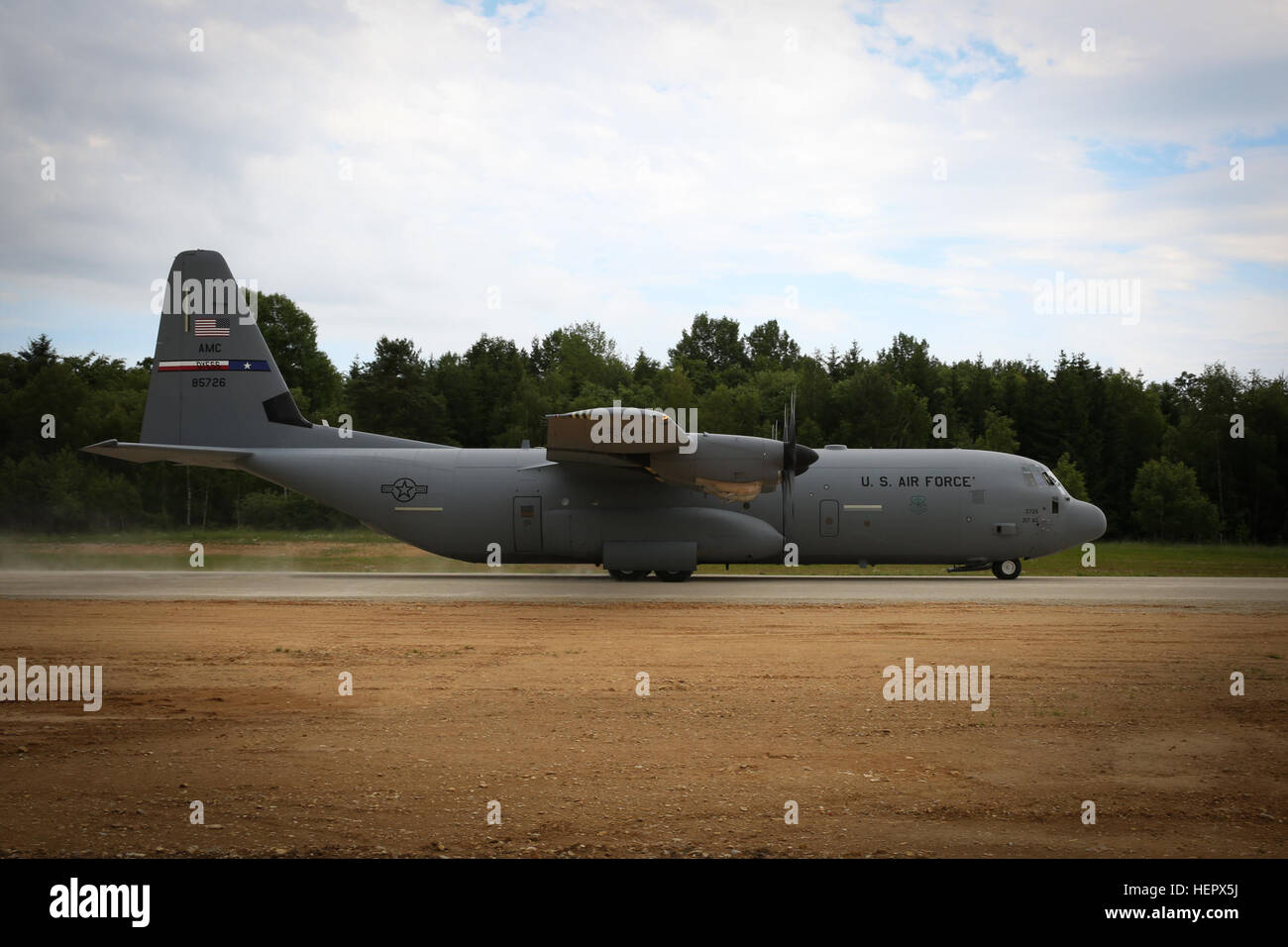 A U.S. Air Force Lockheed C-130 Hercules of 317th Airlift Group taxis on a JMRC’s Short Takeoff and Landing Strip while conducting an AirLand operations to establish lodgement during Swift Response 16 training exercise at the Hohenfels Training Area, a part of the Joint Multinational Readiness Center, in Hohenfels, Germany, Jun. 16, 2016. Exercise Swift Response is one of the premier military crisis response training events for multi-national airborne forces in the world. The exercise is designed to enhance the readiness of the combat core of the U.S. Global Response Force – currently the 82nd Stock Photo