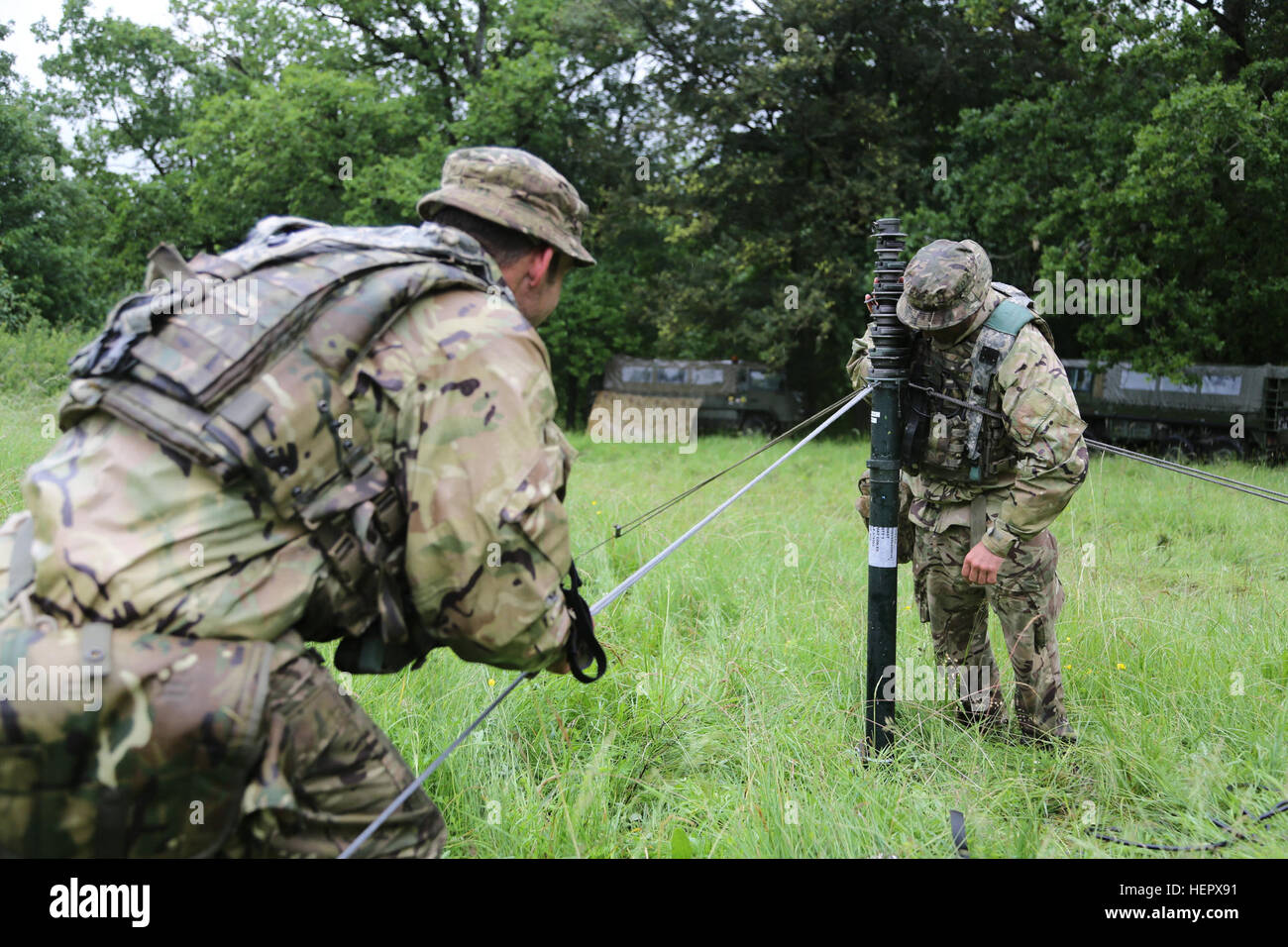 British soldiers of the 7th Parachute Regiment Royal Horse Artillery assemble a communications array while holding position during Swift Response 16 training exercise at the Hohenfels Training Area, a part of the Joint Multinational Readiness Center, in Hohenfels, Germany, Jun. 17, 2016. Exercise Swift Response is one of the premier military crisis response training events for multi-national airborne forces in the world. The exercise is designed to enhance the readiness of the combat core of the U.S. Global Response Force – currently the 82nd Airborne Division’s 1st Brigade Combat Team – to co Stock Photo