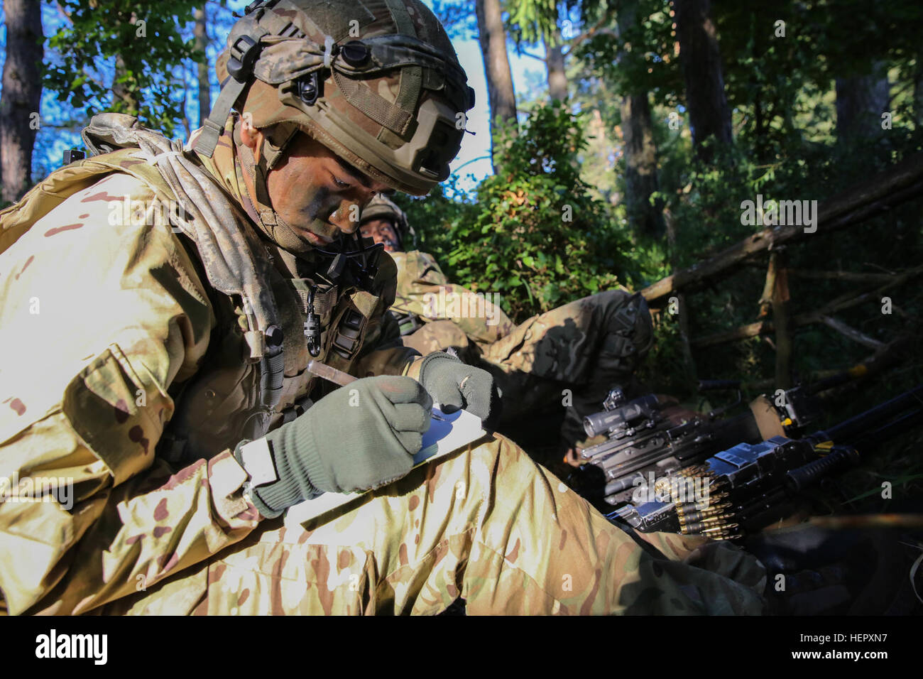 British Pvt. Bishal Sunuwar of 2nd Battalion, Royal Gurkha Rifles writes down simulated enemy’s location while conducting defensive operations during Swift Response 16 training exercise at the Hohenfels Training Area, a part of the Joint Multinational Readiness Center, in Hohenfels, Germany, Jun. 20, 2016. Exercise Swift Response is one of the premier military crisis response training events for multi-national airborne forces in the world. The exercise is designed to enhance the readiness of the combat core of the U.S. Global Response Force – currently the 82nd Airborne Division’s 1st Brigade  Stock Photo