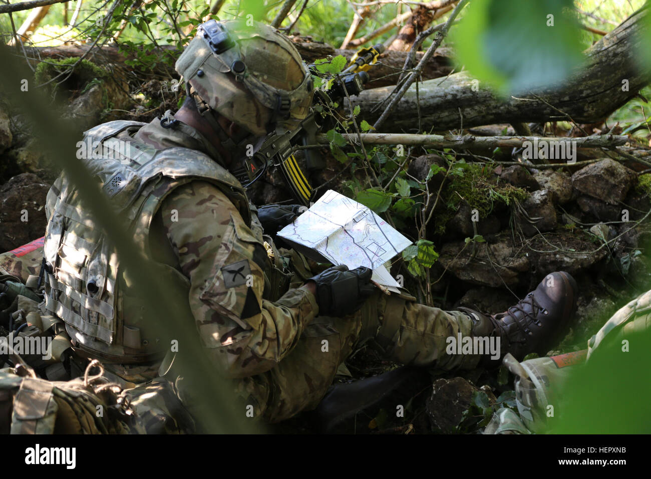 British Army Lance Cpl. Sujan Linbu of the 2nd Royal Gurkha Rifles, Brigade of Gurkhas checks a map of the area while conducting defensive operations during Swift Response 16 training exercise at the Hohenfels Training Area, a part of the Joint Multinational Readiness Center, in Hohenfels, Germany, Jun. 20, 2016. Exercise Swift Response is one of the premier military crisis response training events for multi-national airborne forces in the world. The exercise is designed to enhance the readiness of the combat core of the U.S. Global Response Force – currently the 82nd Airborne Division’s 1st B Stock Photo