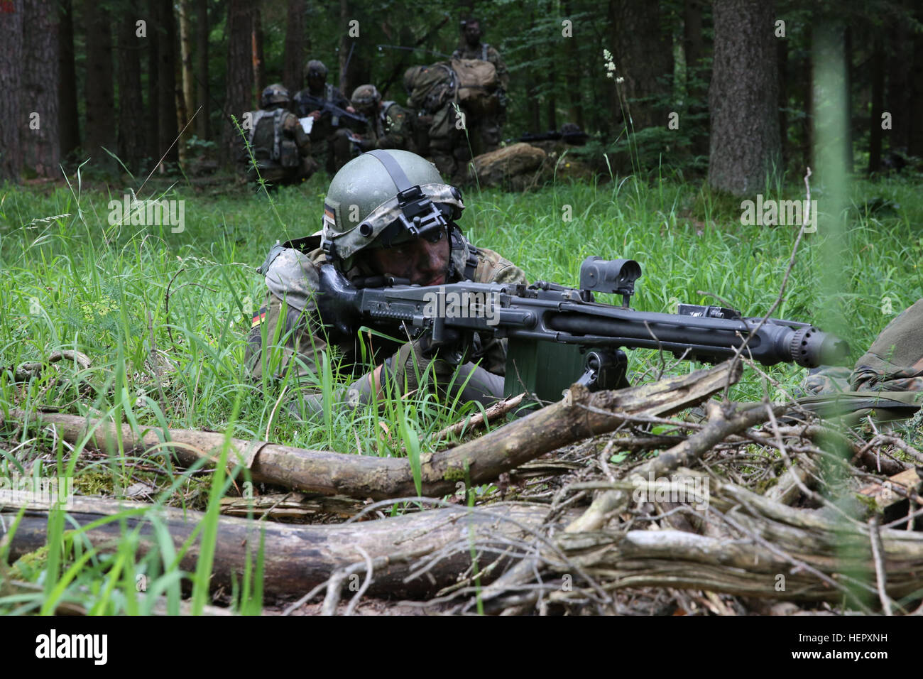 A German Bundeswehr soldier of 4th Paratrooper Company, 31st Paratrooper Regiment, provides security while conducting a dismounted patrol during Swift Response 16 training exercise at the Hohenfels Training Area, a part of the Joint Multinational Readiness Center, in Hohenfels, Germany, Jun. 21, 2016. Exercise Swift Response is one of the premier military crisis response training events for multi-national airborne forces in the world. The exercise is designed to enhance the readiness of the combat core of the U.S. Global Response Force – currently the 82nd Airborne Division’s 1st Brigade Comba Stock Photo
