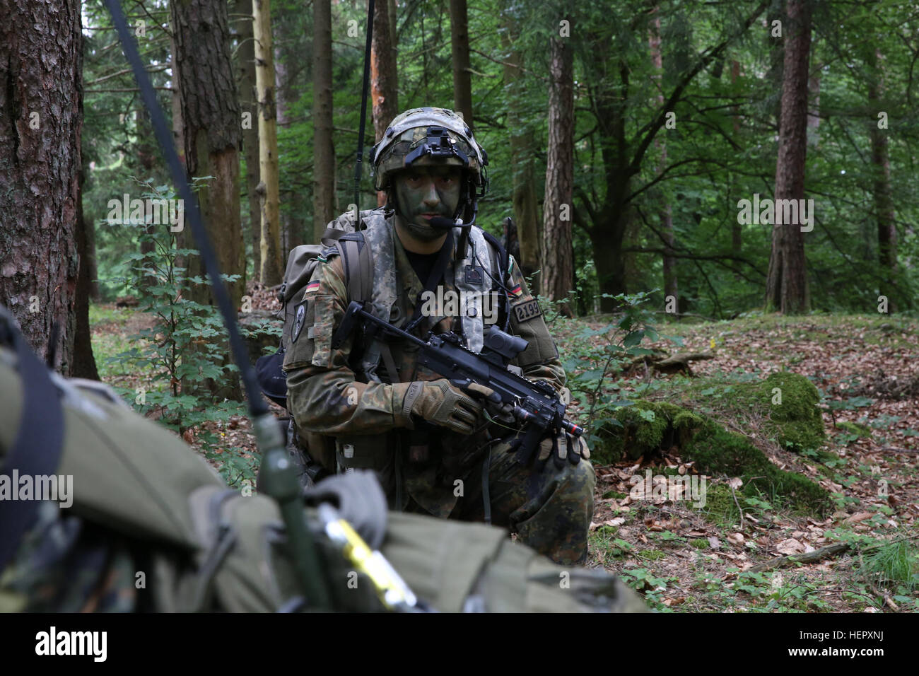 A German Bundeswehr soldier of 4th Paratrooper Company, 31st Paratrooper Regiment, provides security while conducting a dismounted patrol during Swift Response 16 training exercise at the Hohenfels Training Area, a part of the Joint Multinational Readiness Center, in Hohenfels, Germany, Jun. 21, 2016. Exercise Swift Response is one of the premier military crisis response training events for multi-national airborne forces in the world. The exercise is designed to enhance the readiness of the combat core of the U.S. Global Response Force – currently the 82nd Airborne Division’s 1st Brigade Comba Stock Photo