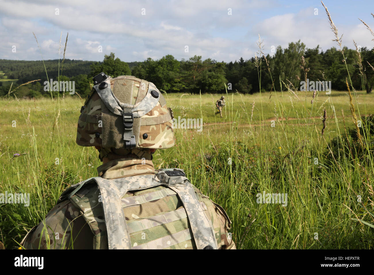 A British soldier of Airborne Combined Joint Expeditionary Force provides security while conducting tactical operations during Swift Response 16 training exercise at the Hohenfels Training Area, a part of the Joint Multinational Readiness Center, in Hohenfels, Germany, Jun. 22, 2016. Exercise Swift Response is one of the premier military crisis response training events for multi-national airborne forces in the world. The exercise is designed to enhance the readiness of the combat core of the U.S. Global Response Force – currently the 82nd Airborne Division’s 1st Brigade Combat Team – to conduc Stock Photo