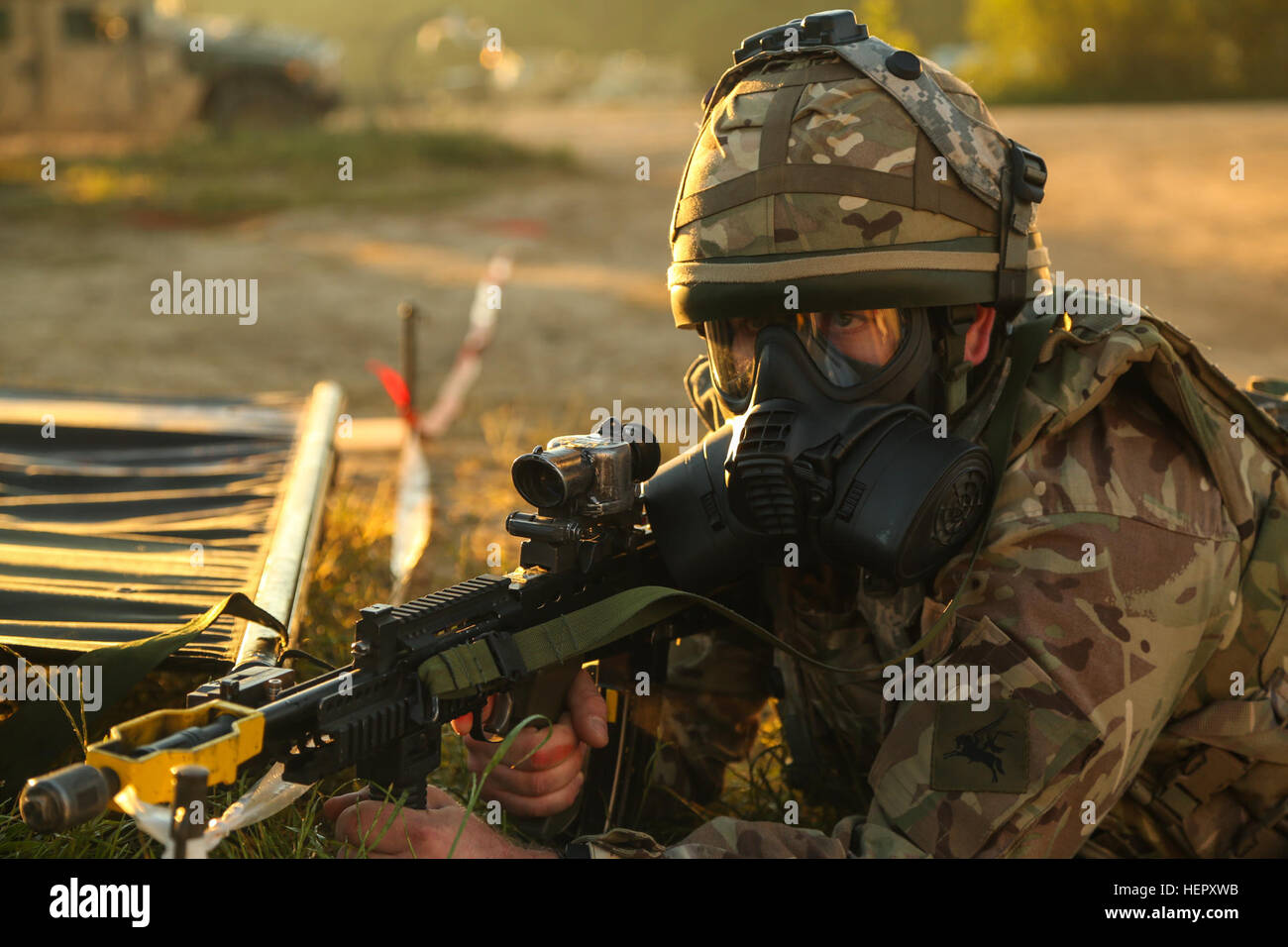 A British soldier of 16 Medical Regiment, 19 Squadron provides security while conducting Medical Evacuation simulations during Swift Response 16 training exercise at the Hohenfels Training Area, a part of the Joint Multinational Readiness Center, in Hohenfels, Germany, Jun. 23, 2016. Exercise Swift Response is one of the premier military crisis response training events for multi-national airborne forces in the world. The exercise is designed to enhance the readiness of the combat core of the U.S. Global Response Force – currently the 82nd Airborne Division’s 1st Brigade Combat Team – to conduc Stock Photo