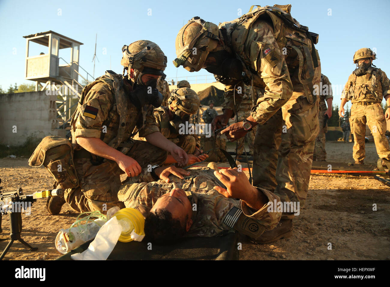 British soldiers of 16 Medical Regiment, 19 Squadron strap in a U.S. Soldier to a litter while conducting Medical Evacuation simulations during Swift Response 16 training exercise at the Hohenfels Training Area, a part of the Joint Multinational Readiness Center, in Hohenfels, Germany, Jun. 23, 2016. Exercise Swift Response is one of the premier military crisis response training events for multi-national airborne forces in the world. The exercise is designed to enhance the readiness of the combat core of the U.S. Global Response Force – currently the 82nd Airborne Division’s 1st Brigade Combat Stock Photo