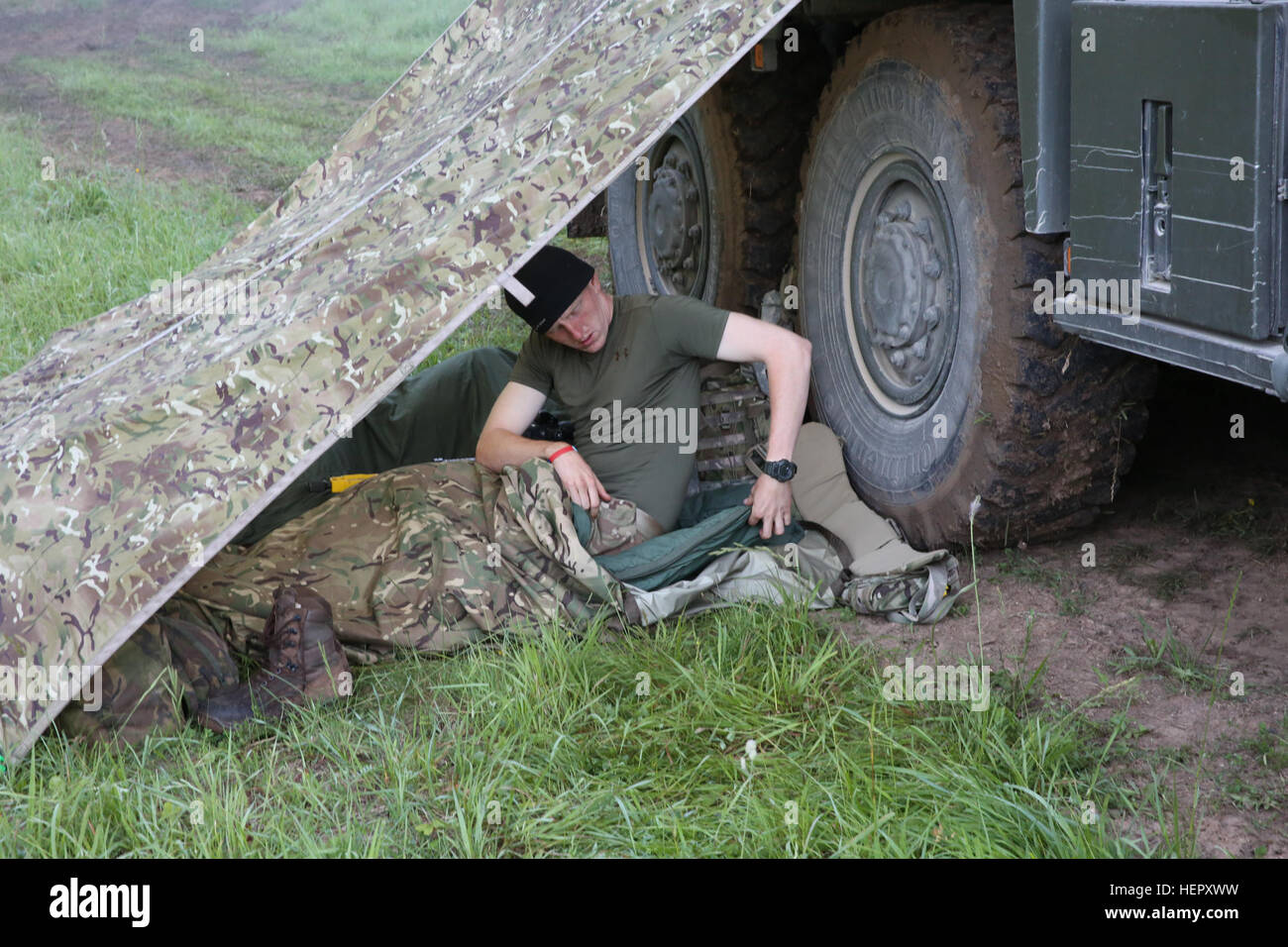 A British soldier of Airborne Combined Joint Expeditionary Force prepares to get some shut eye while conducting tactical operations during Swift Response 16 training exercise at the Hohenfels Training Area, a part of the Joint Multinational Readiness Center, in Hohenfels, Germany, Jun. 23, 2016. Exercise Swift Response is one of the premier military crisis response training events for multi-national airborne forces in the world. The exercise is designed to enhance the readiness of the combat core of the U.S. Global Response Force – currently the 82nd Airborne Division’s 1st Brigade Combat Team Stock Photo