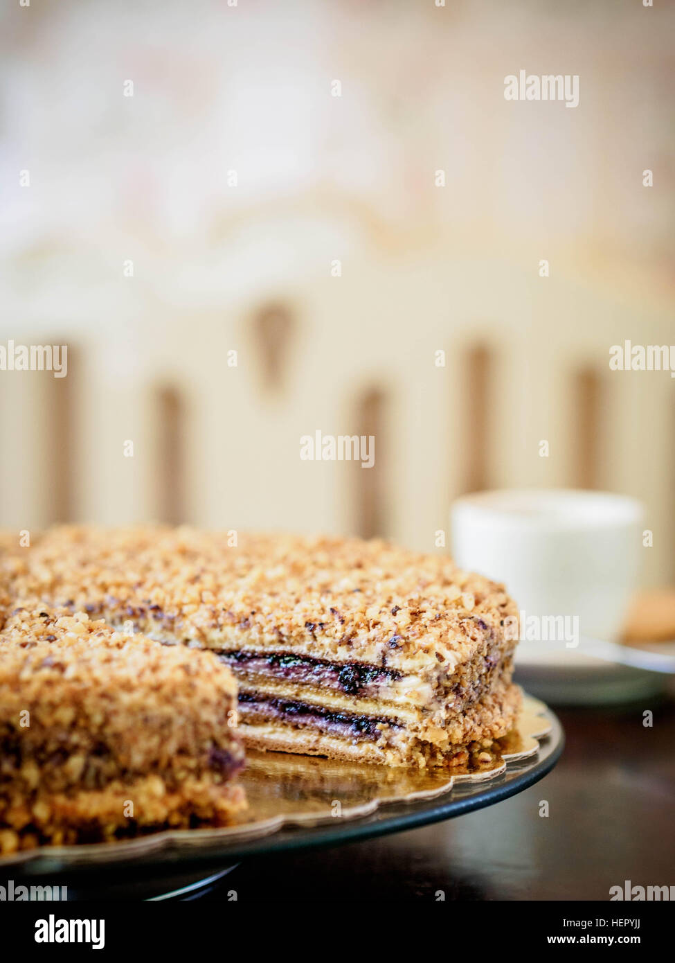 Close-up of a raspberry and nut  cake with missing slice Stock Photo