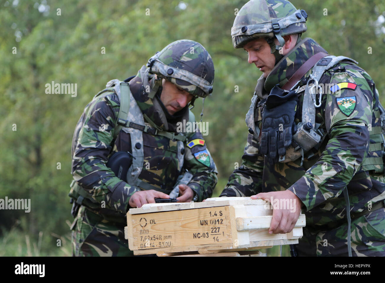 Romanian soldiers of the 3rd Company, 33rd Mountain Battalion, 2nd Mountain Brigade inspect ammo crates before the start of exercise Combined Resolve VII at the U.S. Army’s Joint Multinational Readiness Center in Hohenfels, Germany, Sept. 3, 2016. Combined Resolve VII is a 7th Army Training Command, U.S. Army Europe-directed exercise, taking place at the Grafenwoehr and Hohenfels Training Areas, Aug. 8 to Sept. 15, 2016. The exercise is designed to train the Army’s regionally allocated forces to the U.S. European Command. Combined Resolve VII includes more than 3,500 participants from 16 NATO  Stock Photo