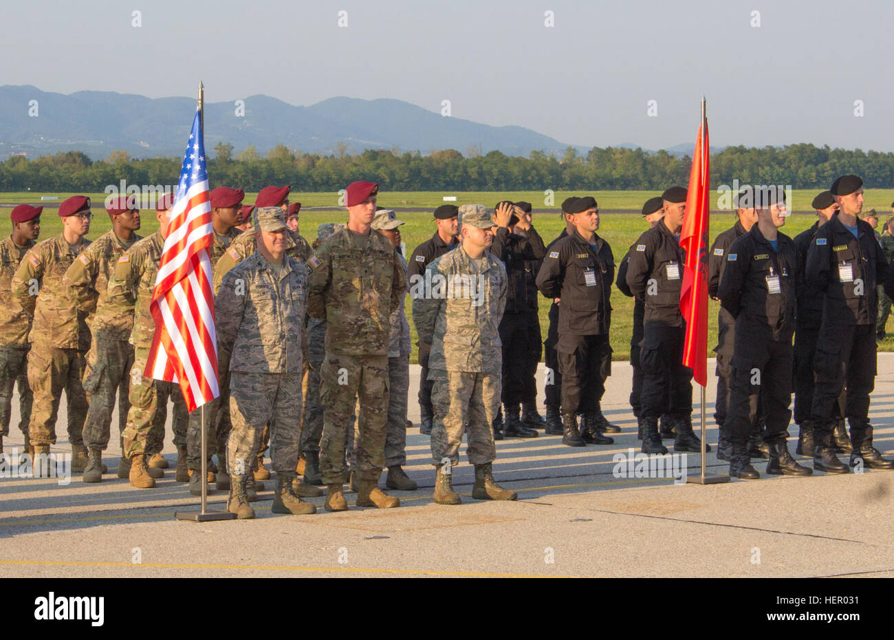 Soldiers and Airmen from the United States stand in formation with multinational partners at the Immediate Response 16 opening ceremony. Immediate Response 16 is a multinational, brigade-level command post exercise utilizing computer-assisted simulations and field training exercises spanning two countries, Croatia and Slovenia. The exercises and simulations are built upon a decisive action based scenario and are designed to enhance regional stability, strengthen Allied and partner nation capacity, and improve interoperability among partner nations. The exercise will occur Sept. 9-23, 2016, and Stock Photo