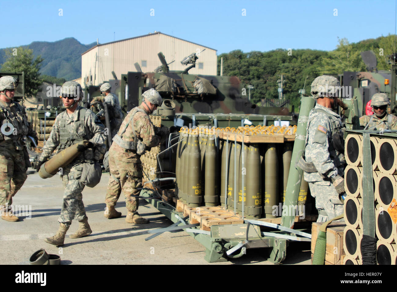 Soldiers from Alpha Battery, 1st Battalion, 82nd Field Artillery Regiment, 1st Armored Brigade Combat Team, 1st Cavalry Division, draw 155mm Base Burn Dual Purpose Improved Conventional Munition rounds, each weighing nearly 100 pounds, and carry into their vehicles during a load exercise directed by the 210th Field Artillery Brigade, 2nd Infantry Division. (U.S. Army photo by 2nd Lt. Gabriel Jenko, 1st Battalion, 82nd Field Artillery Regiment, 1st Armored Brigade Combat Team, 1st Cav. Div.) Loading artillery 160920-A-YZ990-009 Stock Photo