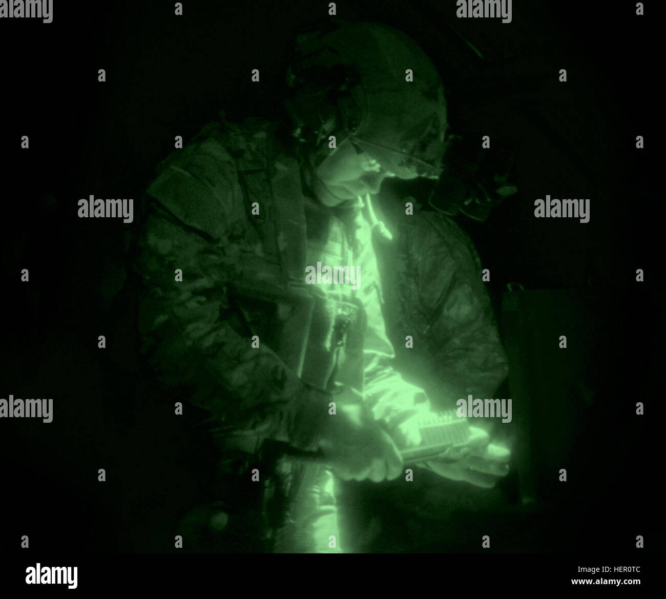 A U.S. Soldier assigned to 1-10th Special Forces Group reloads his ammunition during a weapons training exercise in which the participants were required to rely solely on night vision goggles to see inside the darkened shooting range. This training exercise was held at an indoor shooting range located on Panzer Kaserne, Boeblingen, Germany, Nov. 10, 2016. (U.S. Army photo by Visual Information Specialist Jason Johnston) U.S. Army Special Forces Indoor Weapons Training 161110-A-RY767-111 Stock Photo