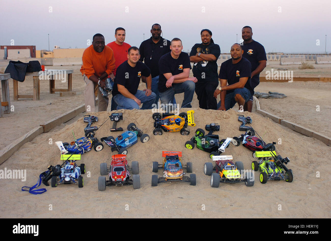 Some of the members of the Cobra Crossing Remote-controlled car Club, made  up of deployed Soldiers and contractors, pose with some of their RC cars in  Kuwait. It's difficult to get all