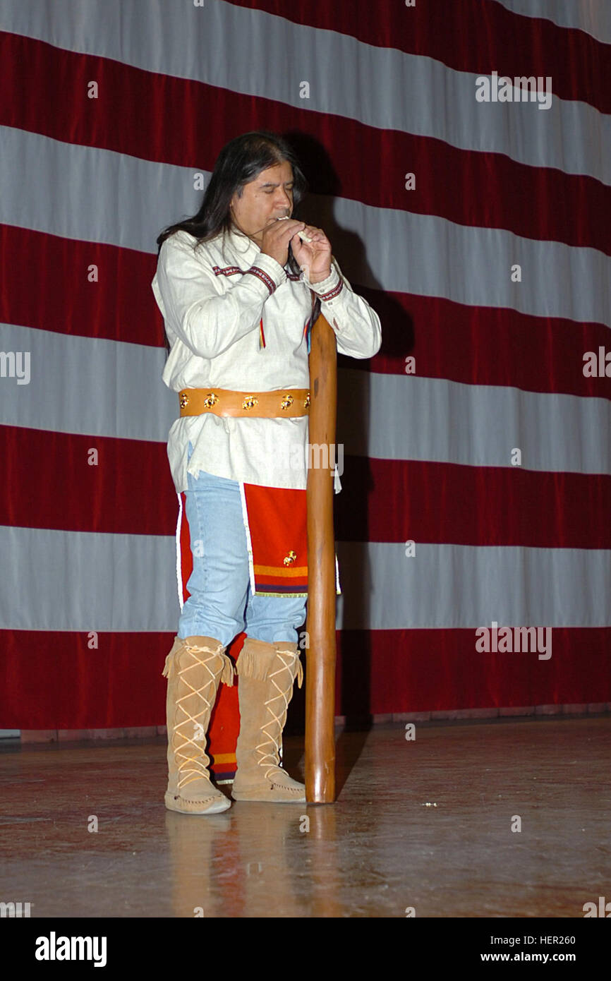Lasaro 'Chief' Arriola, a Comanche-Apache and guest from the Four Winds Intertribal Society, plays an eagle bone flute during the 1st Cavalry Division's National American Indian Heritage Month program at Fort Hood, Texas, Nov. 24. Soldiers got to listen to this as well as many other instruments used by American Indians and indigenous people abroad. Soldiers get glimpse of America's colorful heritage 131343 Stock Photo