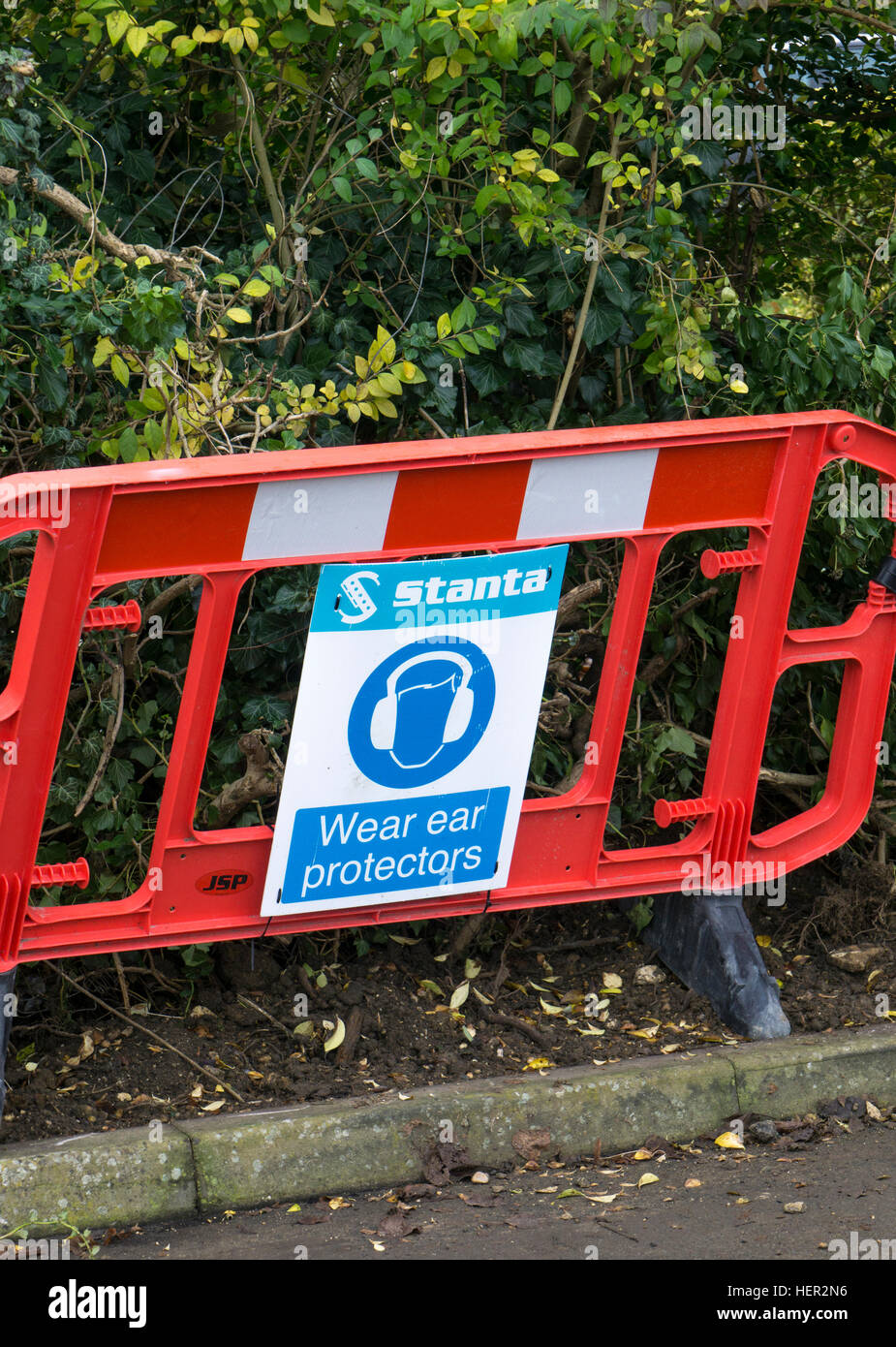 Road works barrier with safety sign Wear ear protectors 2016 Stock Photo