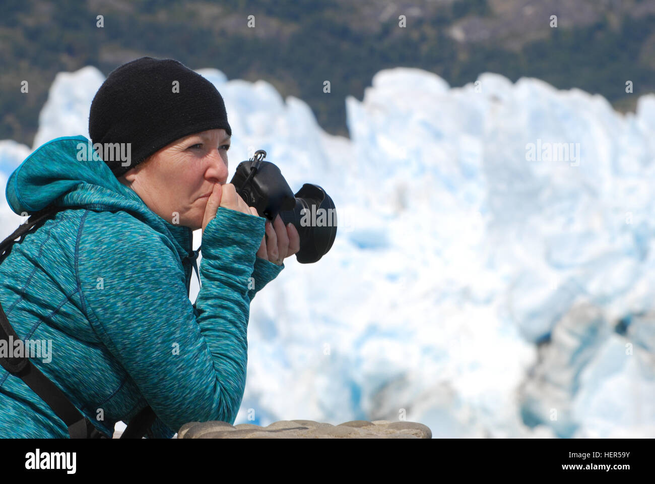 Photographer holding camera looking in awe at Perito Moreno Glacier in Los Glaciares National Park, Argentina. Stock Photo