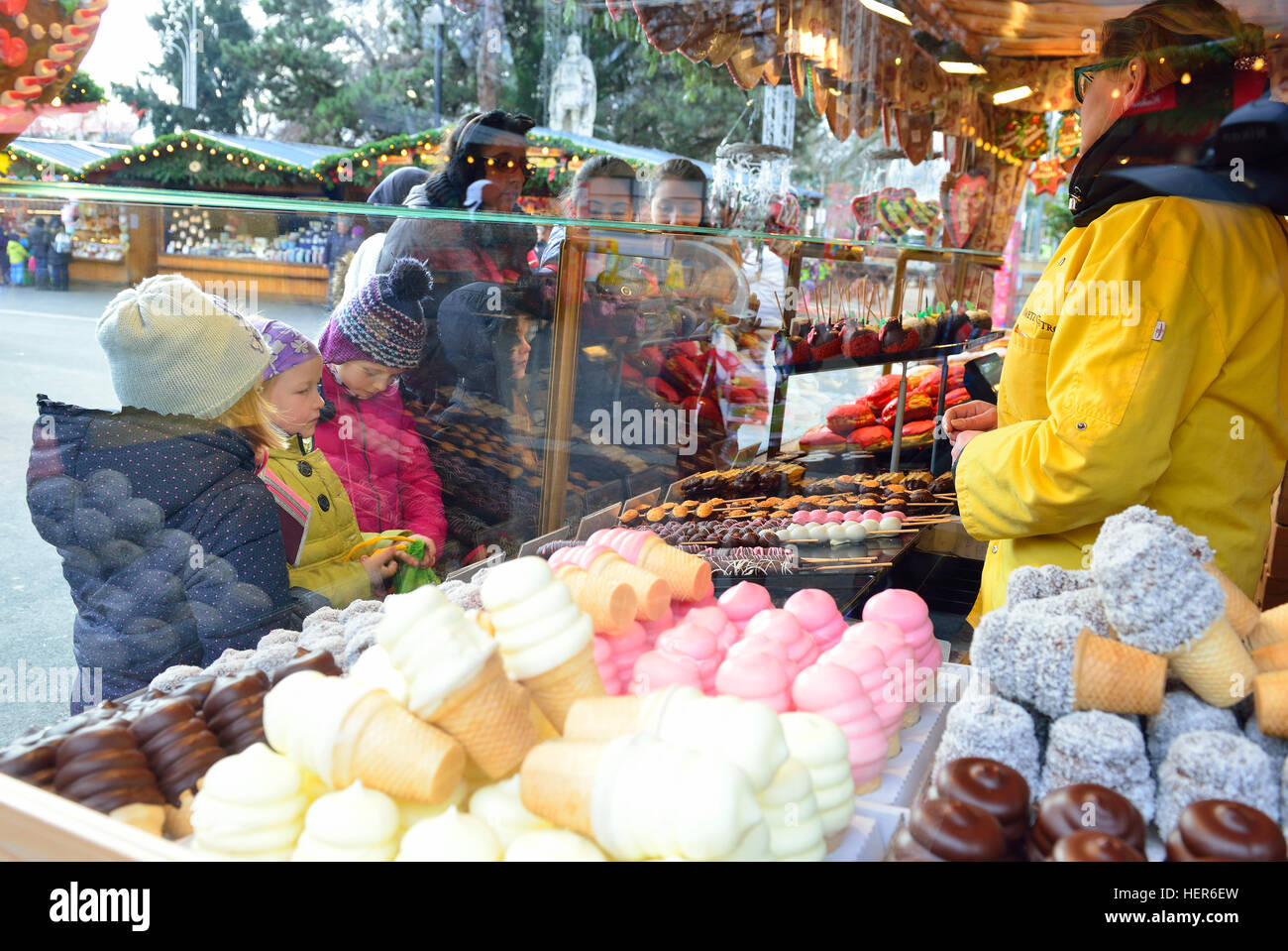 Children at a sweet and cake stall choosing  their delights to purchase at Rathauspark (Rathausplatz) Christmas Market , Vienna, Austria Stock Photo