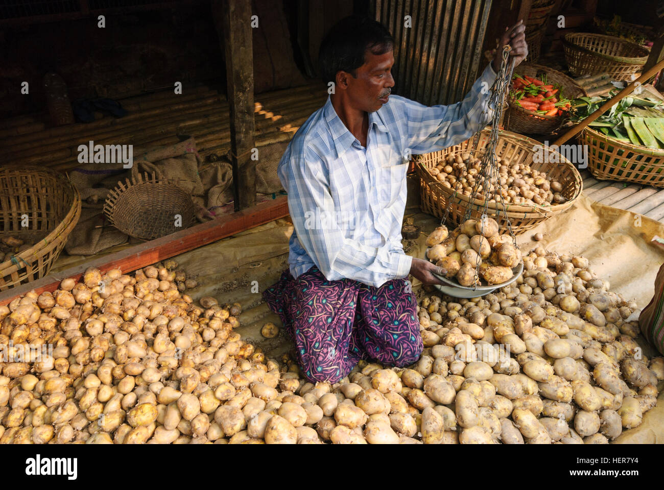 Agartala: Potato trader on a market, Tripura, India Stock Photo