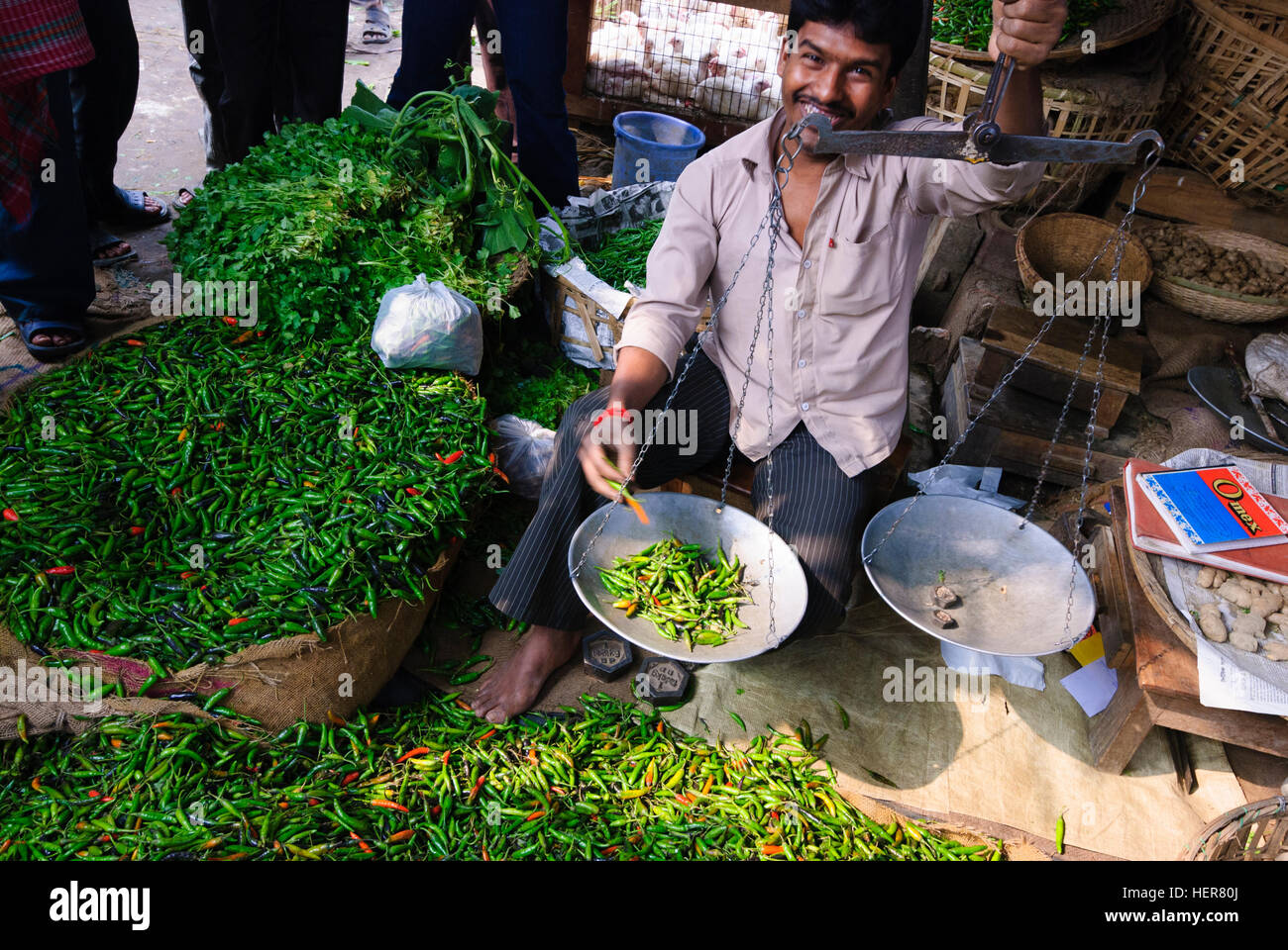 Agartala: Trader with chili peppers at a market, Tripura, India Stock Photo