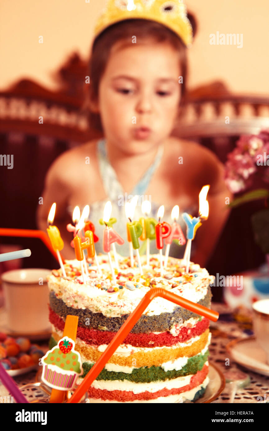 Party Girl blows out candle on her birthday cake Stock Photo Alamy