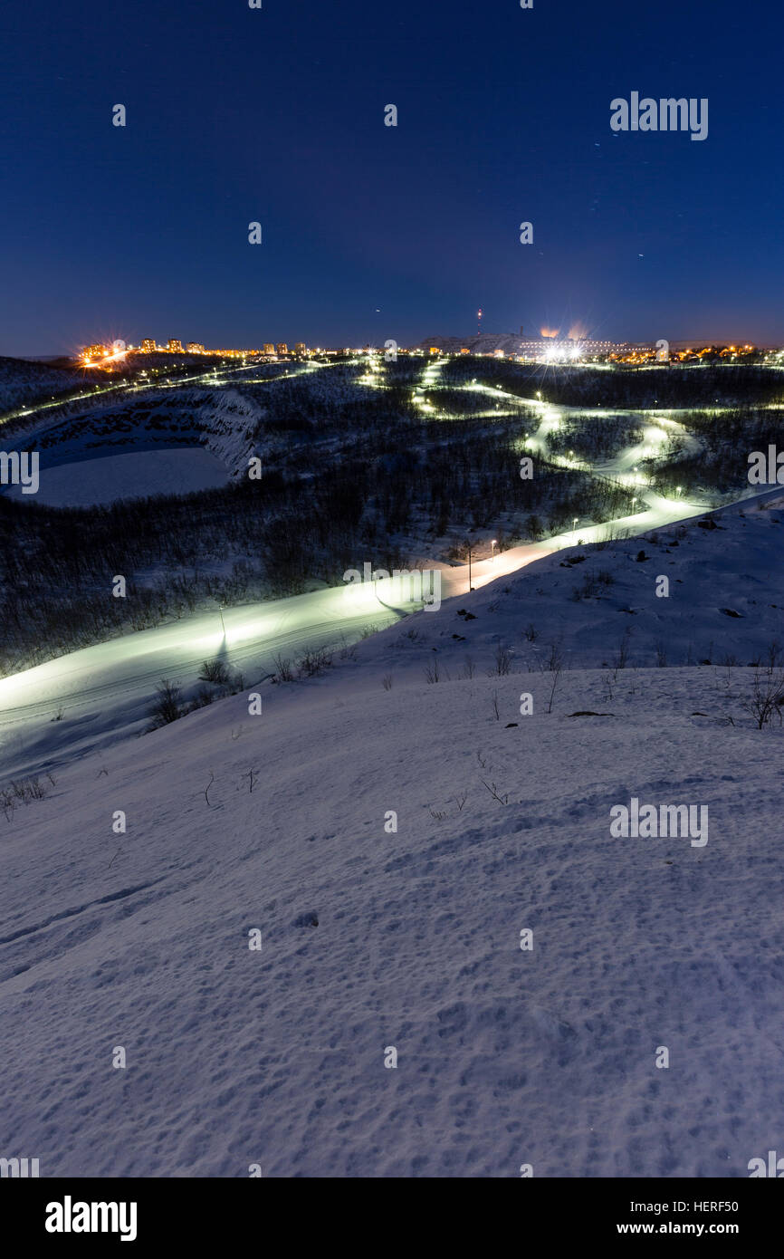Lit cross-country ski trail at night, with Kiruna, Lapland ...