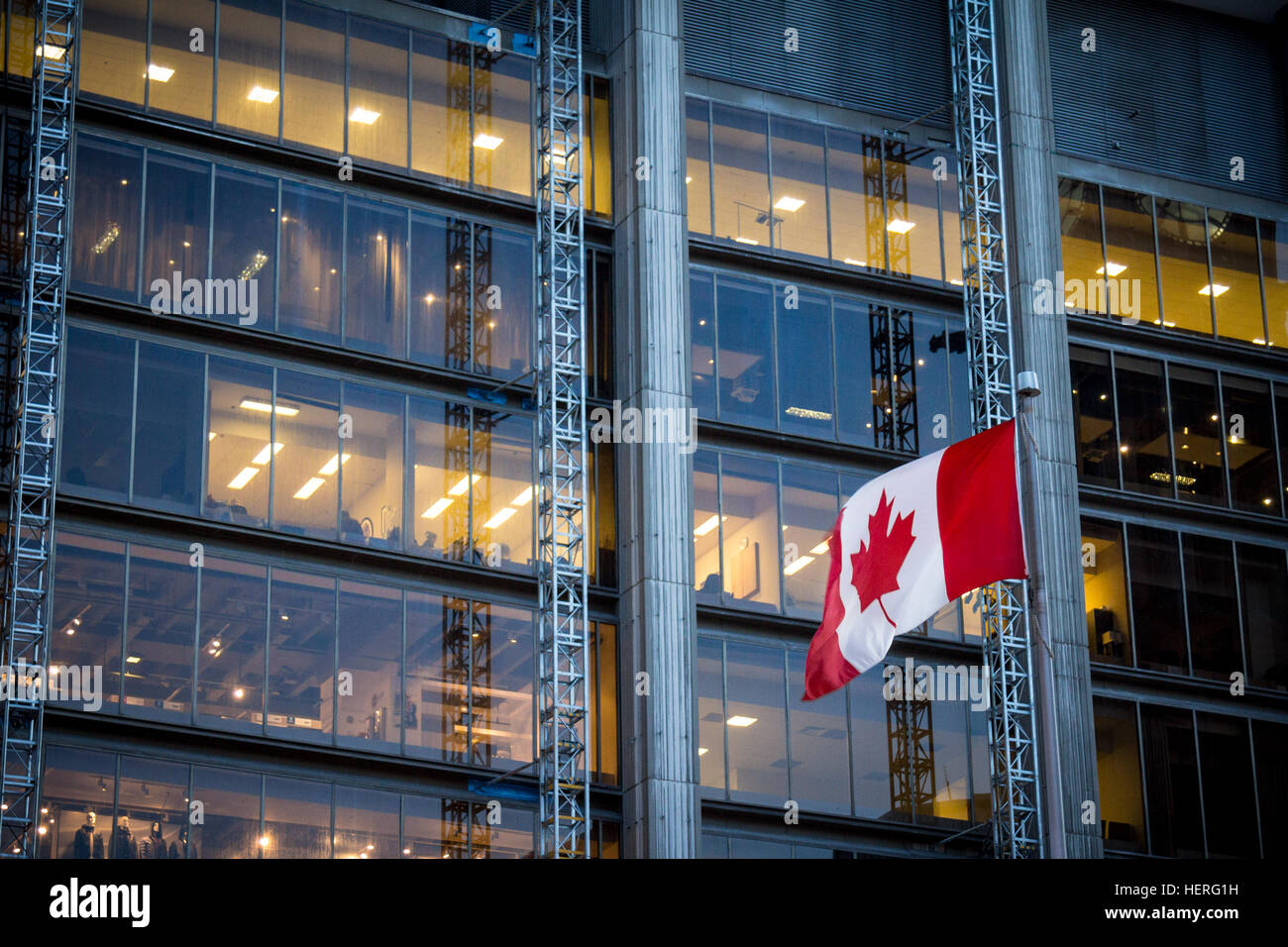 Canadian flag in front of a business building in Toronto Stock Photo