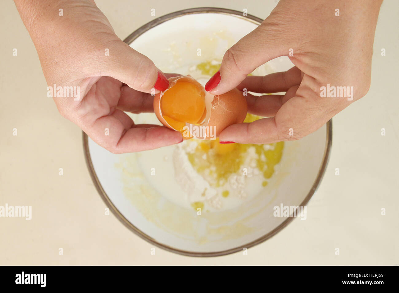 https://c8.alamy.com/comp/HERJ59/woman-cracking-an-egg-into-bowl-of-flour-HERJ59.jpg