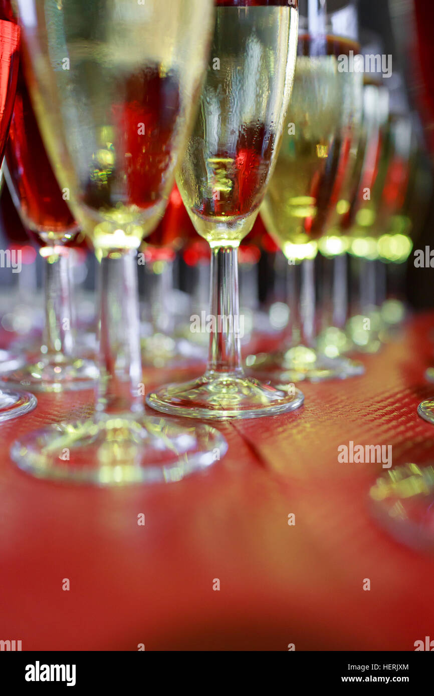 Rows of glasses filled with red and white wine laid out in neat rows at