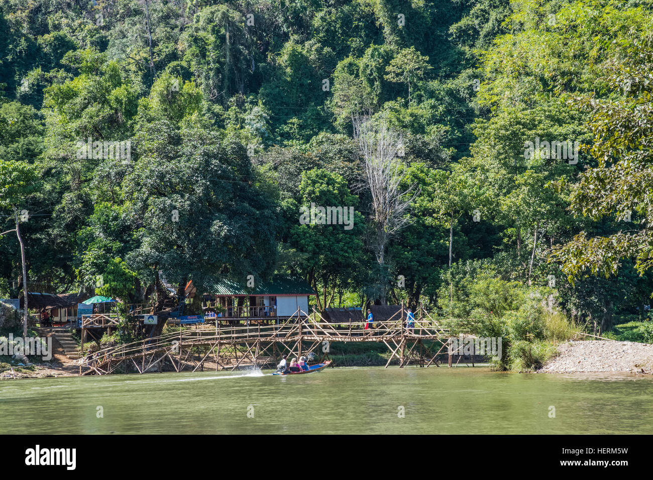 Canoeing and bamboo bridges at Vang Vieng on the Nam Song River Stock Photo