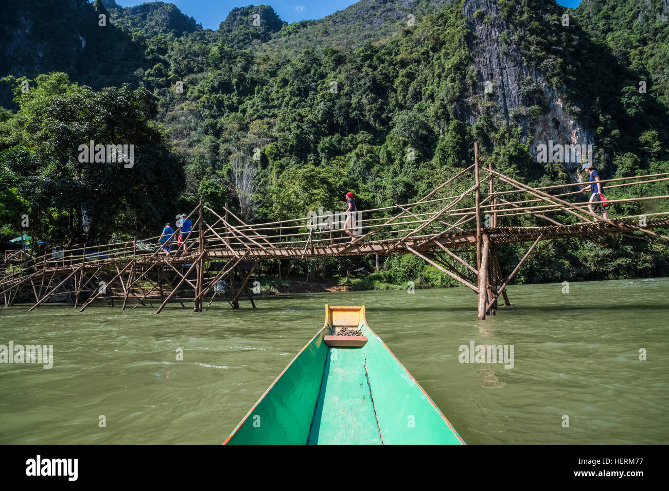 Canoeing and bamboo bridges at Vang Vieng on the Nam Song River Stock Photo
