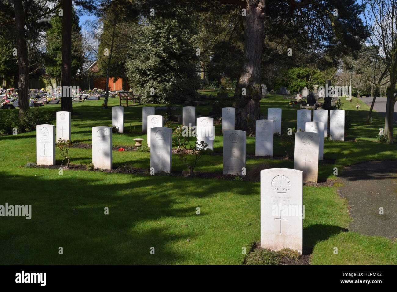Australian Imperial Force (AIF) War Graves in Stourbridge Cemetery, England against a wooded/shaded background Stock Photo