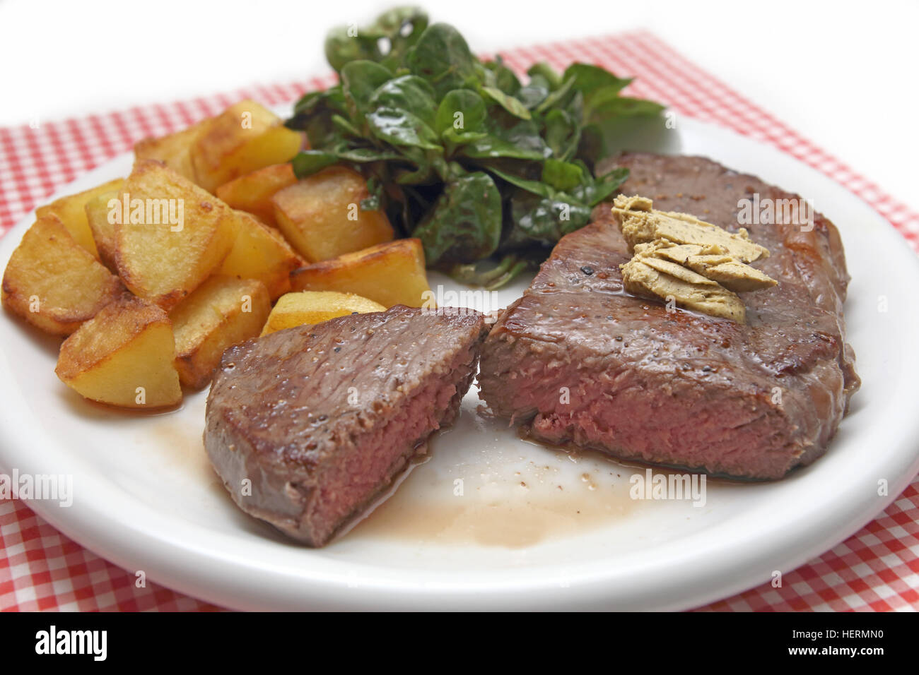 Steak with fried potaoes and corn salad Stock Photo