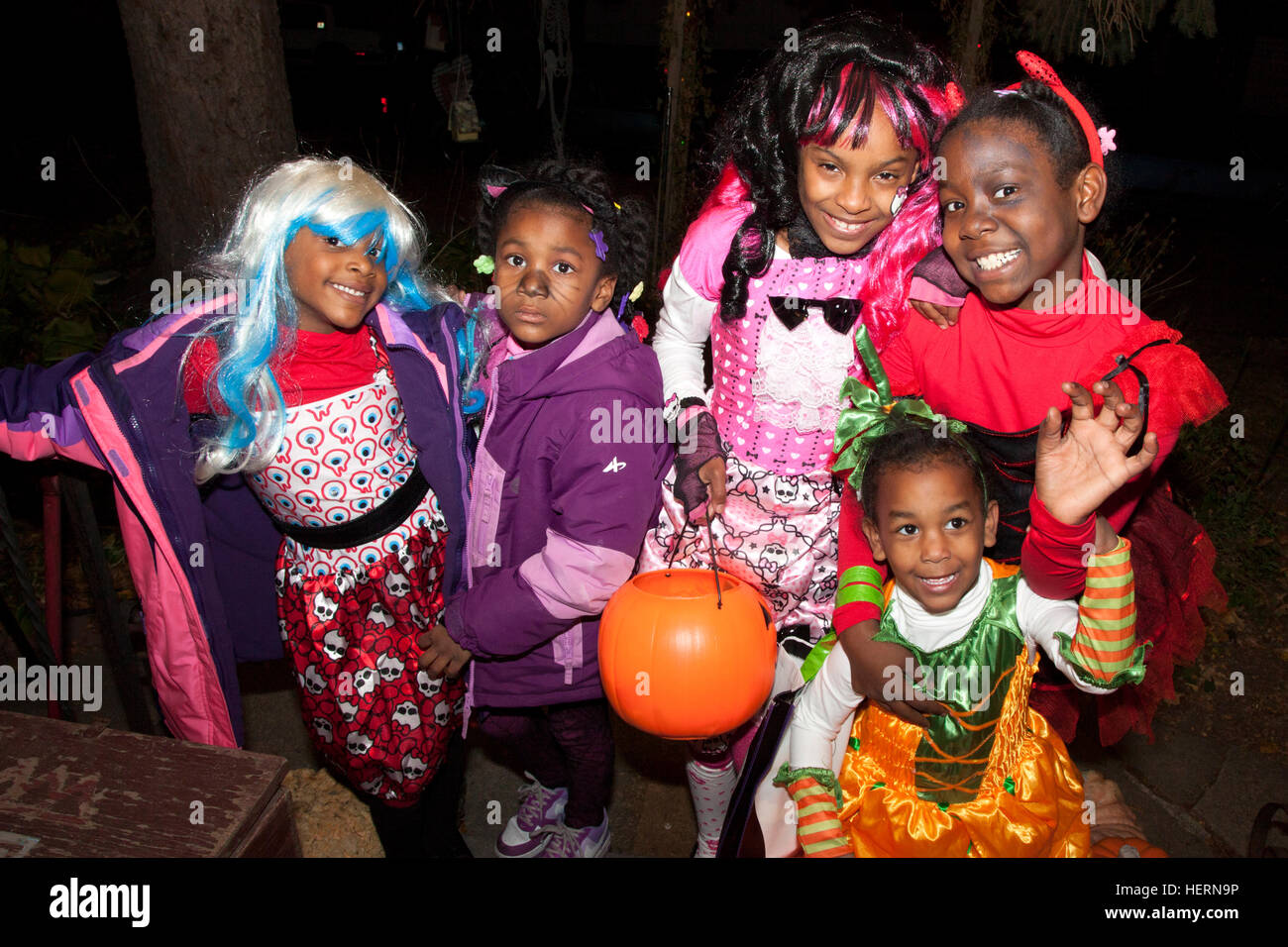 Black kids enjoying trick or treating on Halloween wearing some