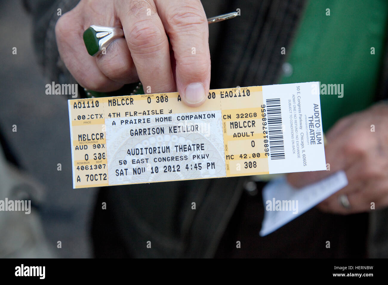 Holding ticket for Prairie Home Companion show starring Garrison Keillor at the Auditorium Theatre. Chicago Illinois IL USA Stock Photo